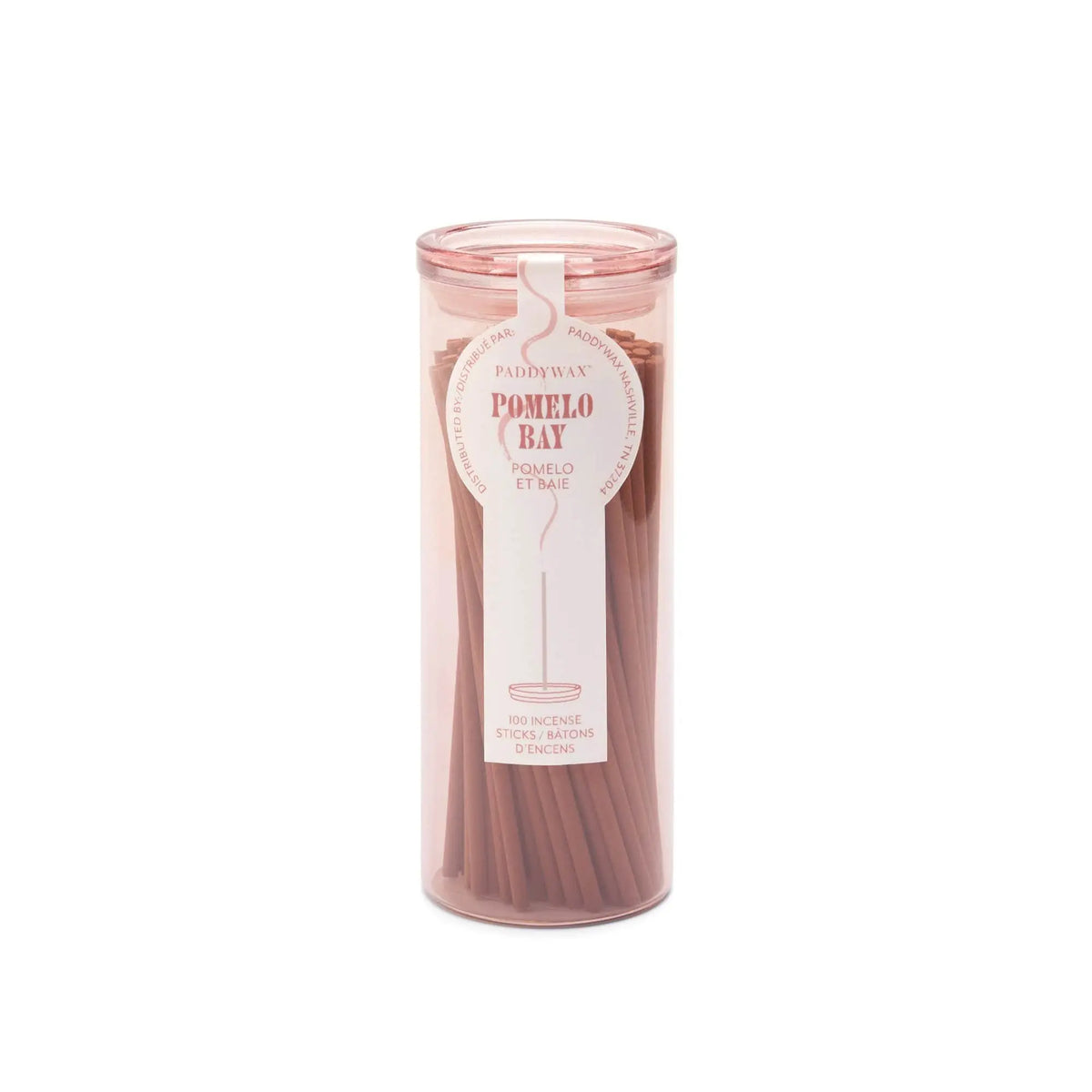 A clear cylindrical holder with a pink lid contains pink Pomelo Bay - Haze Incense sticks. The label highlights the flameless fragrance and states it holds 100 sticks from the incense collection.