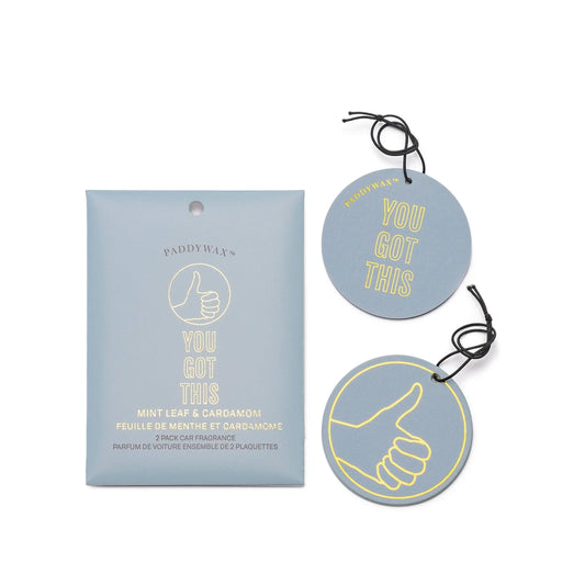 The Mint Leaf + Cardamom "You Got This" Impressions Car Fragrance includes two round air fresheners in blue and yellow with a thumbs up graphic, adding positivity to your car scent collection. From Paddywax.