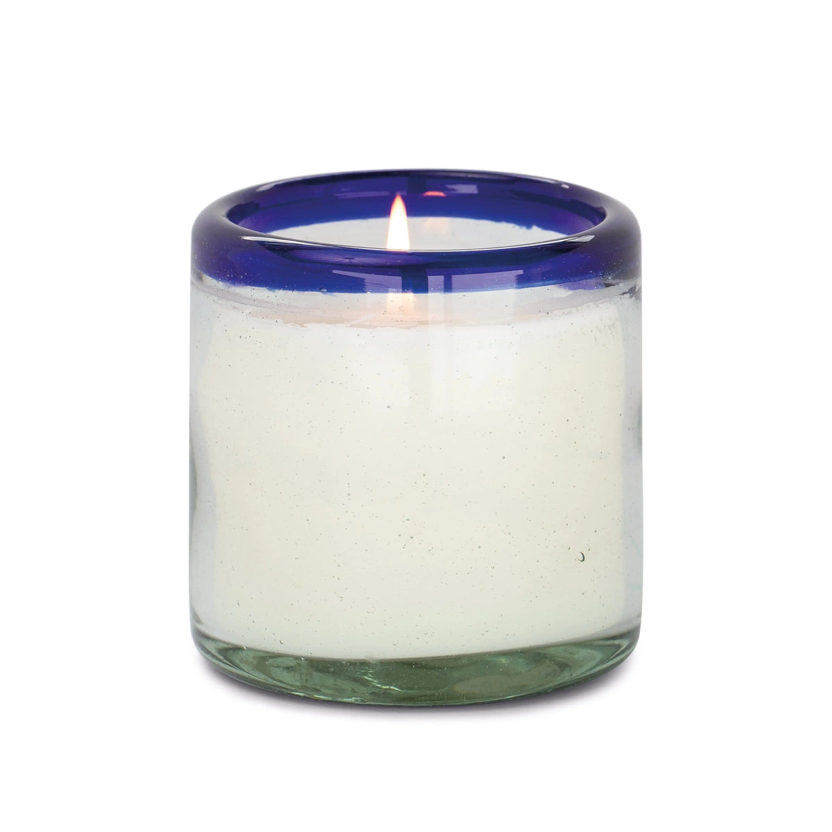 The Salted Blue Agave - La Playa 9 oz Candle is a lit white candle in a clear, hand-blown bubble glass holder with a thick blue rim.