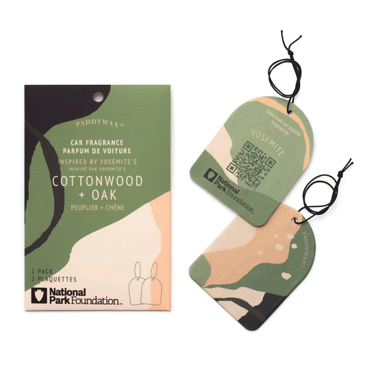 Two camouflage-patterned Yosemite - Parks Car Fragrance air fresheners with black strings and Cottonwood + Oak scent, inspired by Yosemite National Park, from Paddywax and the National Park Foundation.