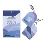 A package and two purple-blue abstract Glacier - Parks Car Fragrance tags labeled White Pine + Hemlock, inspired by the Glacier National Park scent, featuring National Park Foundation branding and a QR code on one tag—perfect as a stylish car air freshener.