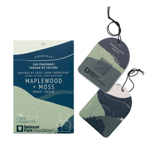 The Great Smoky Mountains - Parks Car Fragrance includes a package with two air fresheners by Paddywax, offering the National Park Foundation's Maplewood + Moss scent and featuring green and blue abstract landscape designs.