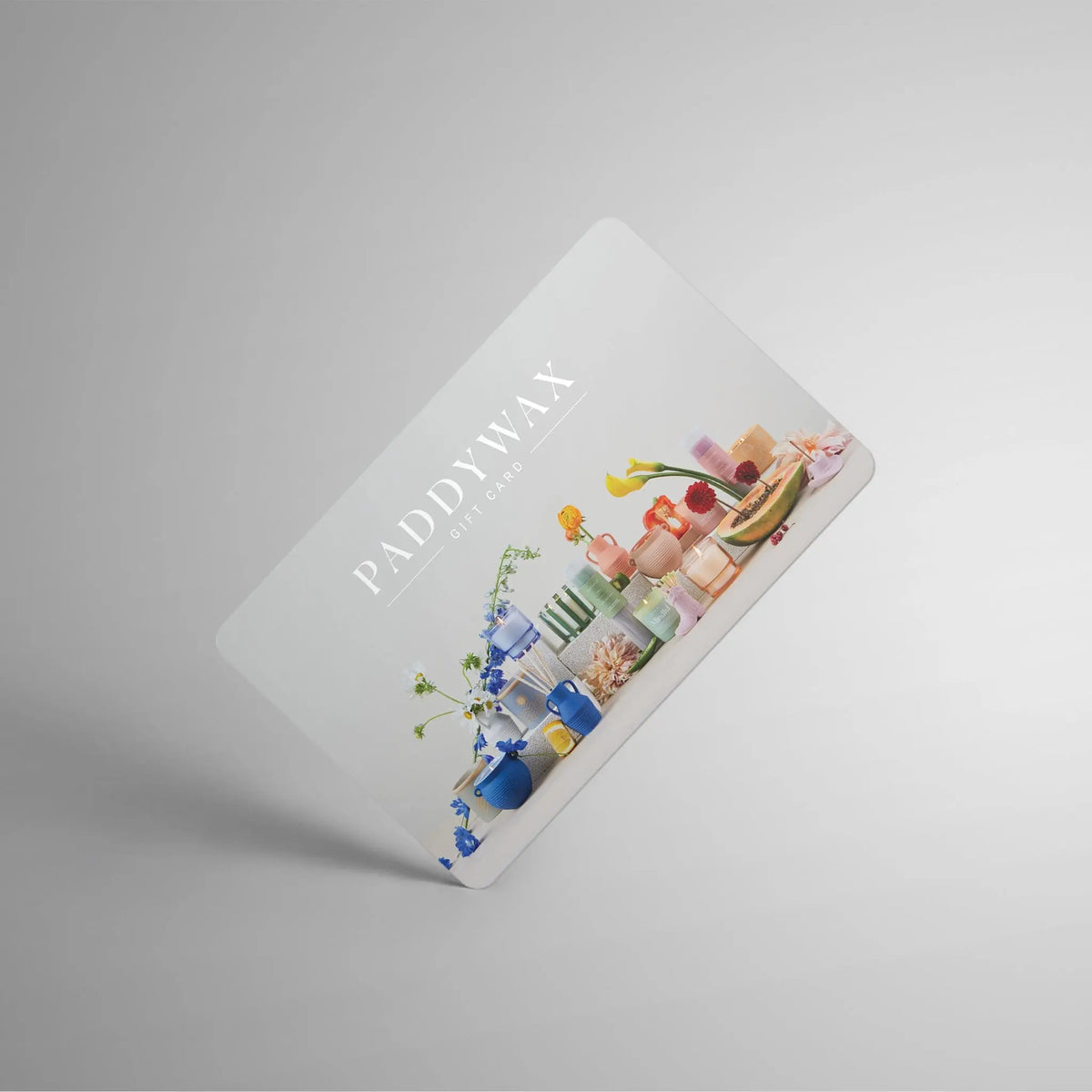 A Paddywax E-Gift Card showcasing vibrant candles, vases, and decor neatly arranged on a white background, with "PADDYWAX E-GIFT CARD" at the top—this digital card delivers instantly via email for a seamless gifting experience.