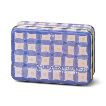 The Wild Flowers & Fern - 5 oz Tin Candle comes in a rectangular tin with a blue and cream geometric design, filling your space with the fresh scent of wild flowers and fern.