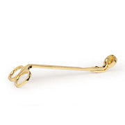 The Wick Trimmer is a brass candle accessory featuring two finger holes and a small cutting blade at the tip, perfect for neatly trimming wicks.